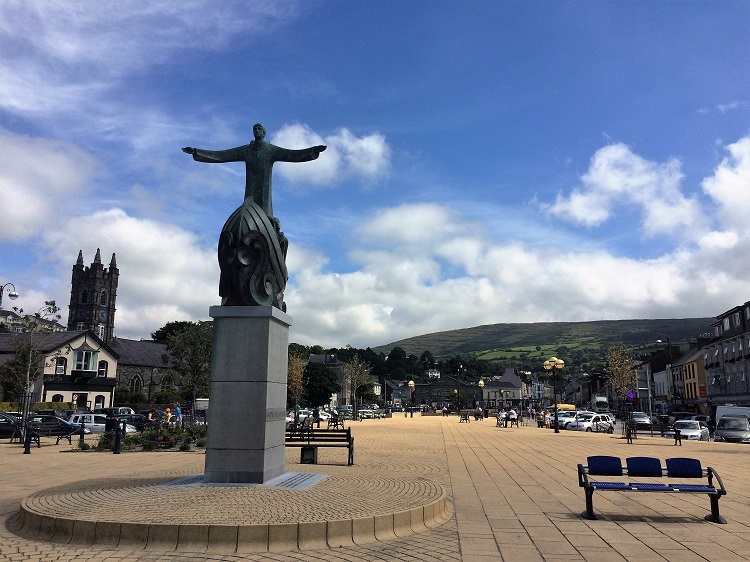 St. Brendan the Navigator's statue stands open-armed facing out to Bantry Bay